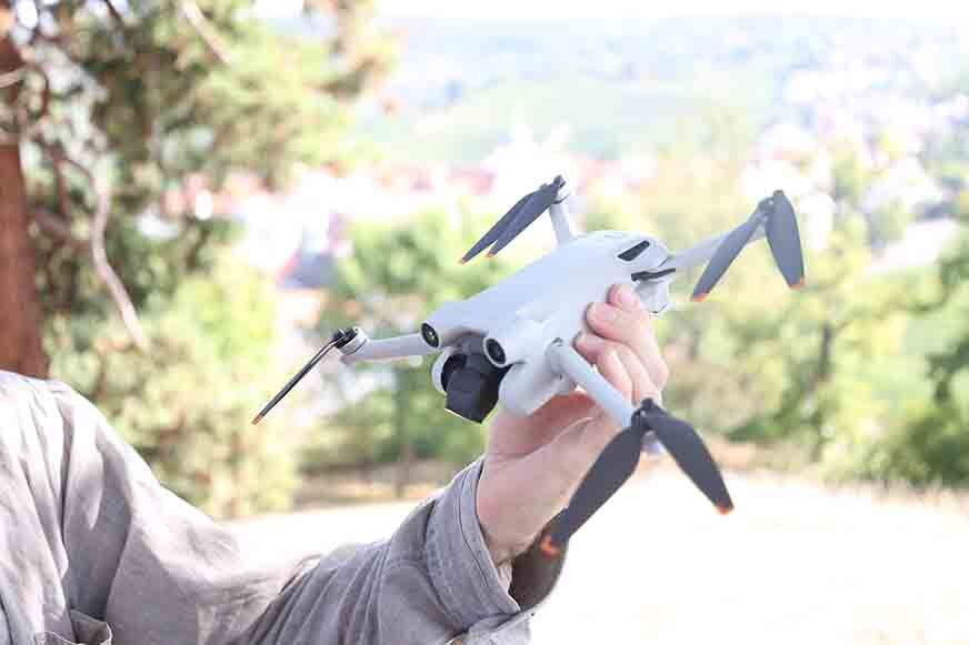 The DJI Mini 3 Pro hovers in the air.